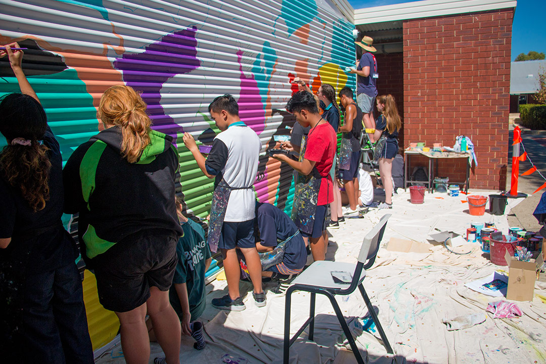 Students painting a mural with Fieldey at Safety Bay Senior High
